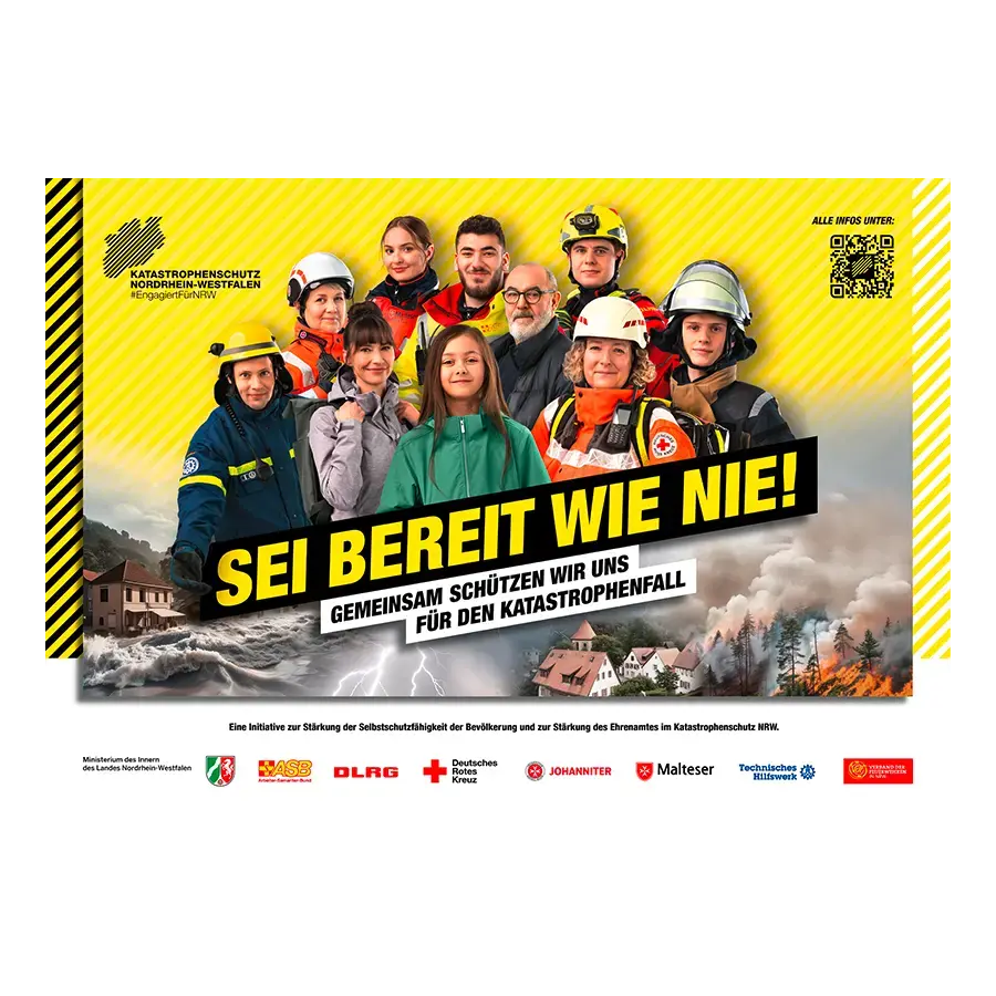 Eine Gruppe aus Katastrophenschützerinnen und Zivillisten stehen vor einem gelben Hintergrund. Auf dem Bild steht der Slogan &quot;SEI BEREIT WIE NIE!&quot;